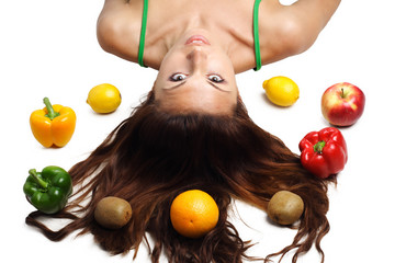 Beautiful woman lying with fruits hair is dishevelled isolated