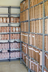Archive with many folders on a metal shelf