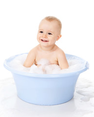 The little boy bathes in a bath