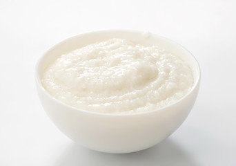 rice porridge in white bowl - obrazy, fototapety, plakaty
