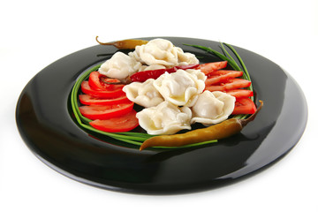 dumplings with peppers on black
