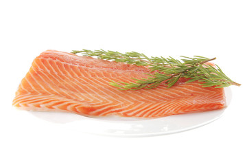 salmon fillet on white plate and rosemary