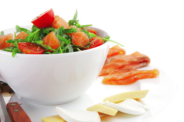 salad with smoked salmon in white bowl