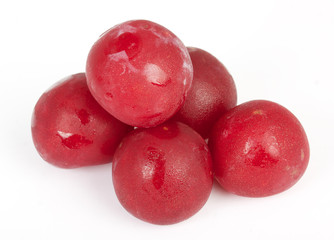 Shiny purple plum isolated against white background