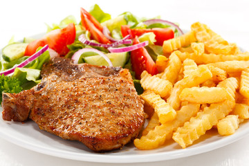 Fried pork chop with chips and vegetables