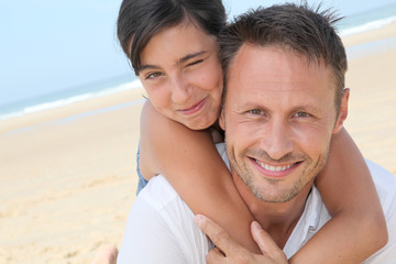 Closeup of father and daughter at the beach