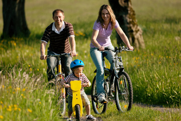 Fototapeta premium Family riding bicycles in summer