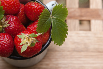 Strawberry in a mug on a table