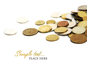 Heap of coins isolated on white background (shallow DOF)