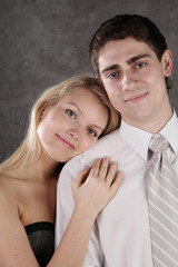 beautiful girl with long hair embraces the young man.