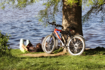 Couple relaxing in the park with parked bicycle
