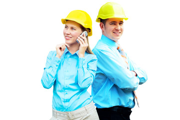 Young architects wearing a protective helmet standing on the bui