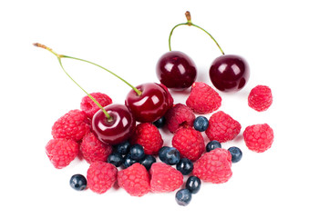 Raspberries, cherry and bilberry on white background