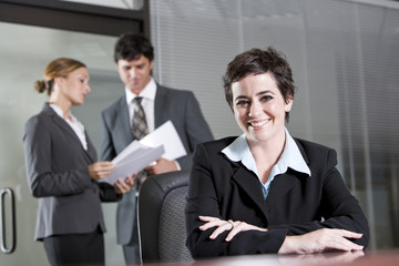 Three office workers meeting in boardroom