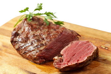 roasted meat on a cutting board. isolated object