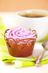 cupcake with lavender icing top in festive wrap and coffee cup