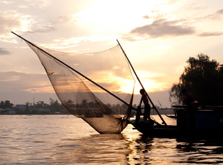 Fishing boat with net silhouette in Can Tho, Mekong delta, Vietnam