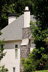 Stone Chimney on Grey Stucco House