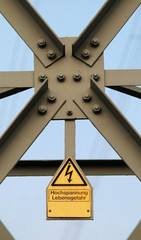 warning sign at electrical tower