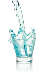 Glass with splashing blue drink