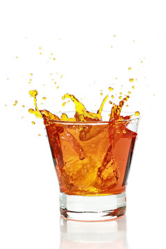 Glass with splashing whisky drink