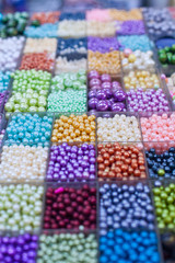 Beads in boxes on a Thai sunday market Chatuchak