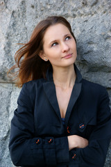 Woman near grey stone wall