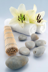 Towels with stones, flower and rolled mate