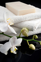 Fototapeta na wymiar Rectangle soap on white towels on black background