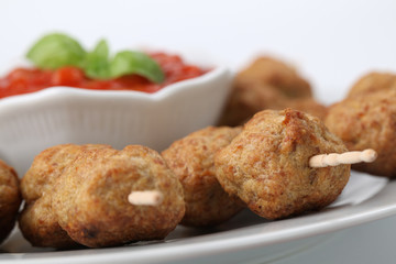 Roast meatballs on skewers and tomato dip. Shallow DOF