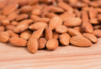 Almonds spread on a wooden table top