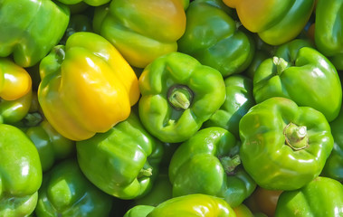 Obraz na płótnie Canvas Green peppers in a basket - background