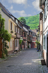 Fototapeta na wymiar Charming lane with half-timbered houses in Kaysersberg