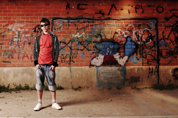 Young Teenager against Graffiti Wall