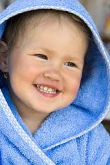 girl in a blue hood smiles