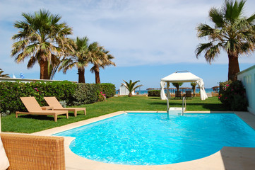 Swimming pool with jacuzzi at the beach of modern luxury villa, - obrazy, fototapety, plakaty