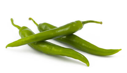 Three green chili peppers on white