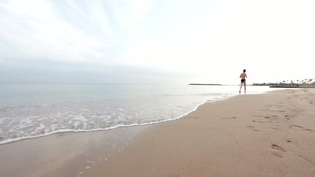 Man runs on the beach