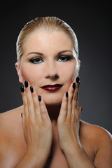Fototapeta na wymiar pretty woman with bright make-up and dark manicure