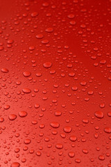 rain drops on orange car body, shallow focus