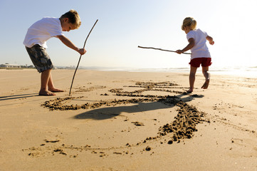 Kids writing in sand