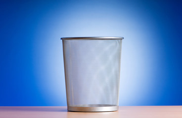 Garbage bin with paper waste isolated on white