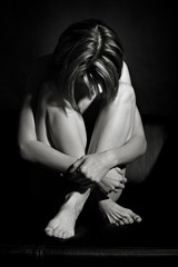 Naked woman on black background