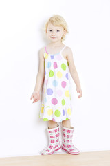 little girl wearing dress and rubber boots