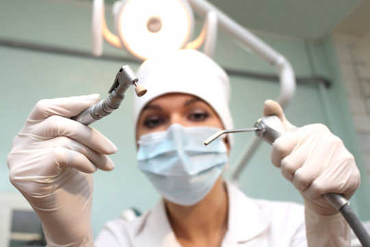 Dentist with instrument