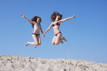 two girls on a sand-pit