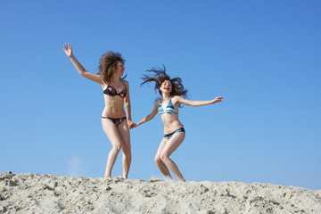 two girls on a sand-pit