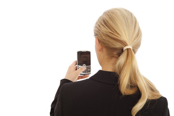 Back view portrait of young business girl texting on cell phone