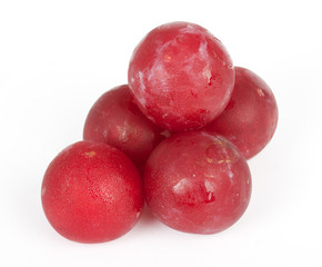 Shiny purple plum isolated against white background