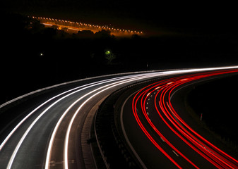 Highway with car lights trails at night